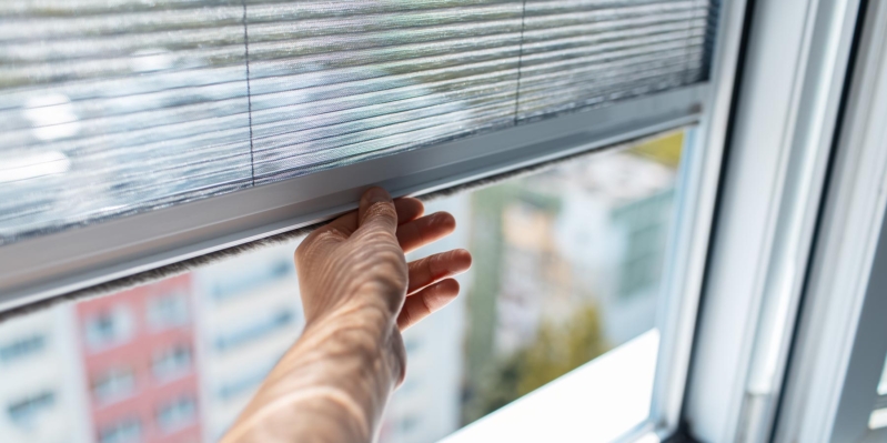 closeup-male-hand-trying-open-modern-mosquito-net-plastic-window(1)